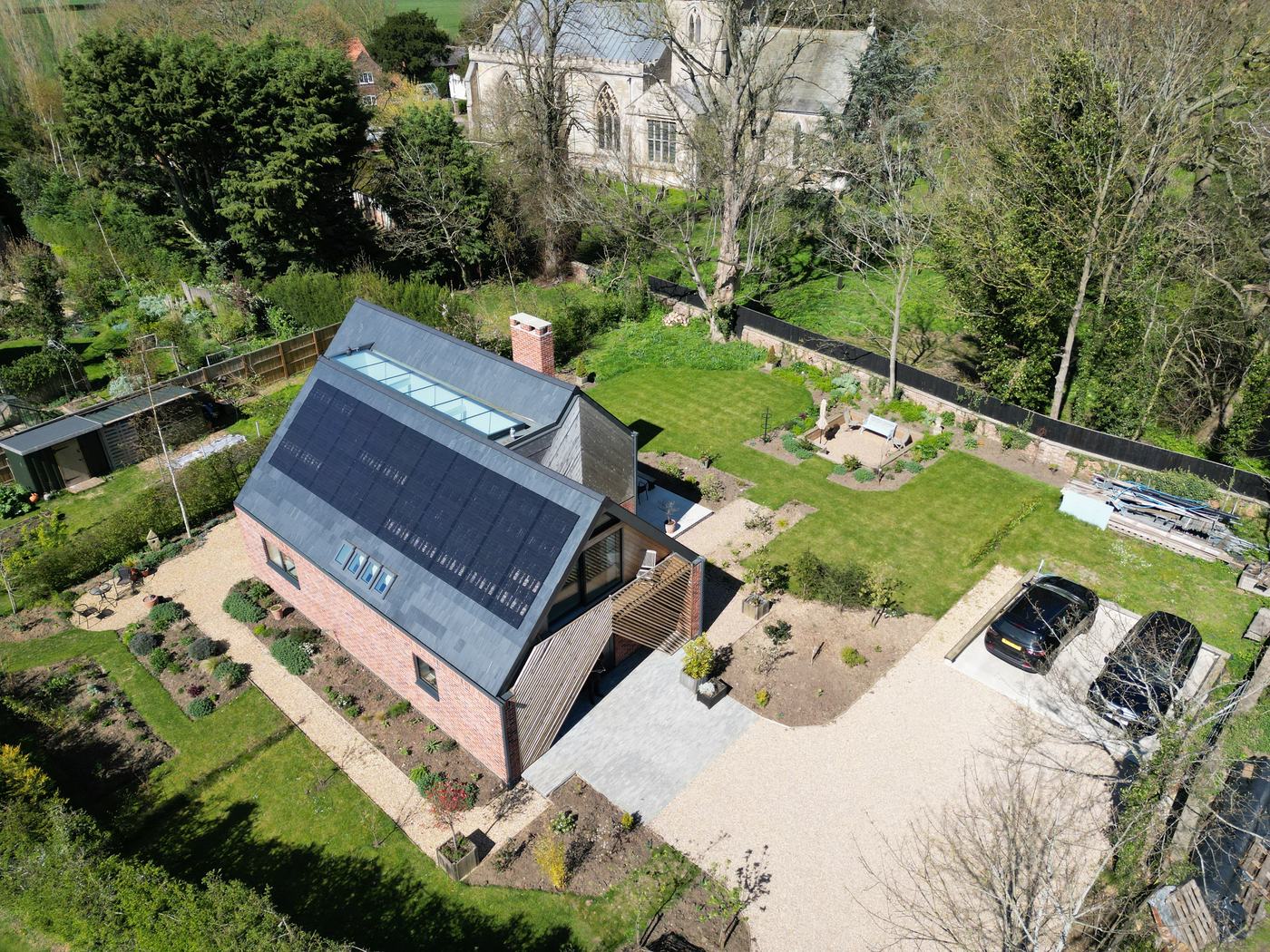 Aerial photograph of a completed home with full integrated solar roof